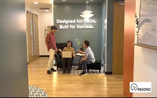 The Resono reception, team talking beneath the brand wall